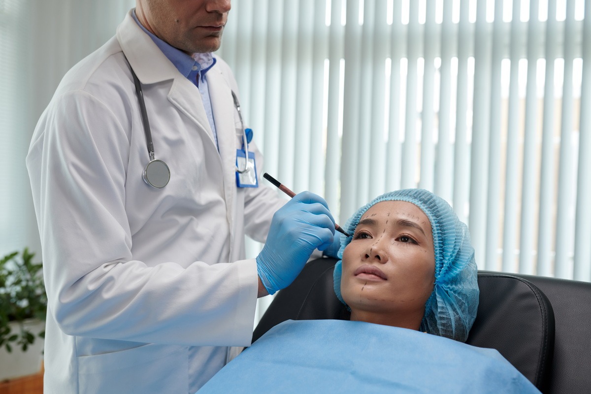 Provider's Page Header image of Doctor performing plastic surgery on a young woman