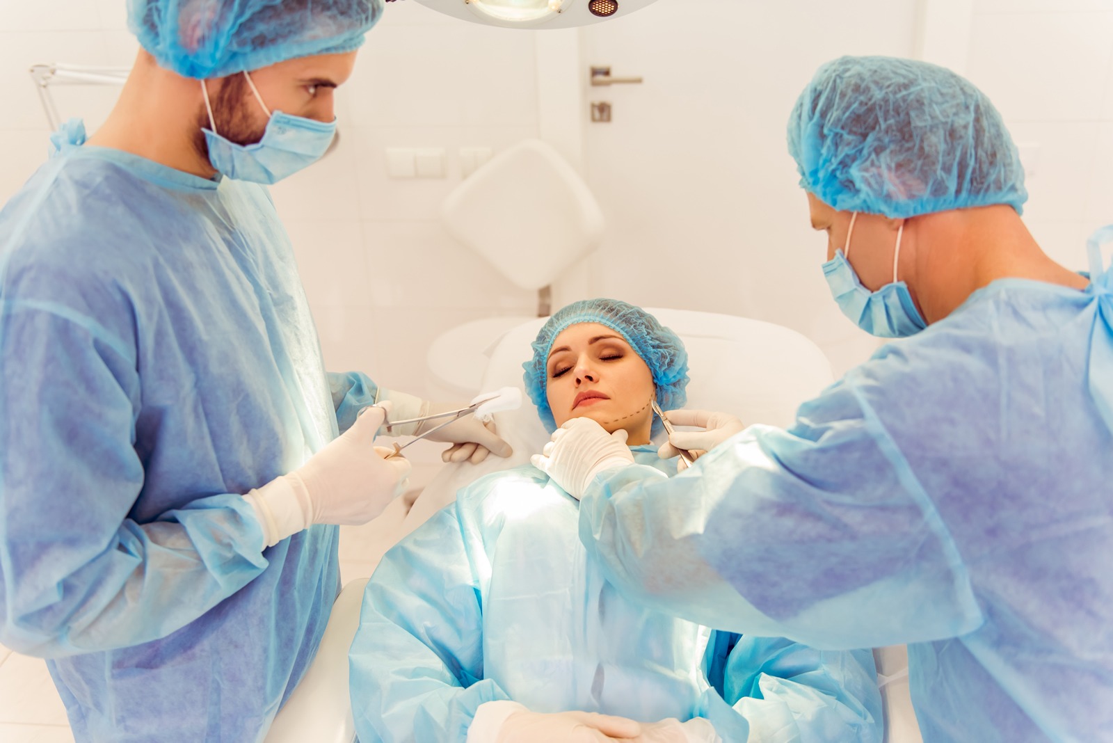 Team of Surgeons preparing woman patient for Plastic Surgery Face Lift